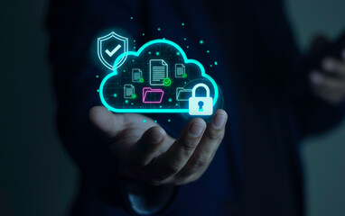 Businessman holding a Secure Cloud Storage icon. Cybersecurity concept with shield and padlock protecting digital files and data.