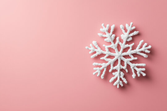 Minimal christmas concept with white snowflake on pastel pink background creating calm festive mood for winter holiday decoration - Powered by Adobe