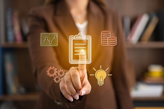 Businesswoman touching virtual icons signifying planning and strategy concept