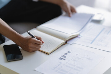 Businessman reviewing company documents and financial reports at office desk
