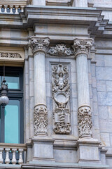 A close-up of the Banco de España facade in Madrid, highlighting classical architectural forms and decorative elements that evoke history, artistry, and tradition