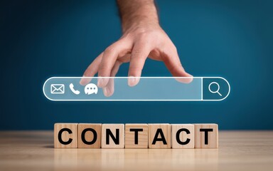 Businessman searching for contact information with icons for email, phone, and chat above wooden blocks