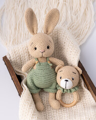 Soft, hand-knitted toys. A hare and a teddy bear. A gift for a child.