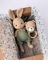 Soft, hand-knitted toys. A hare and a teddy bear. A gift for a child.