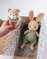 Soft, hand-knitted toys. A hare and a teddy bear. A gift for a child.