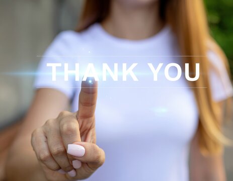 A woman gestures with her finger, displaying the text "THANK YOU," conveying appreciation and gratitude in a vibrant, engaging manner.