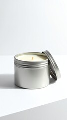 Stylish silver candle in modern container.
