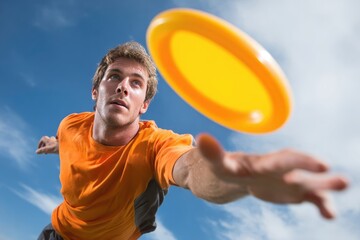 Man catching ultimate frisbee disk during outdoor sport