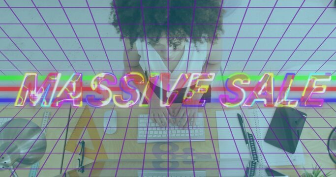 Typing woman wearing white blouse using white keys at home office desk, showing MASSIVE SALE grid - Powered by Adobe