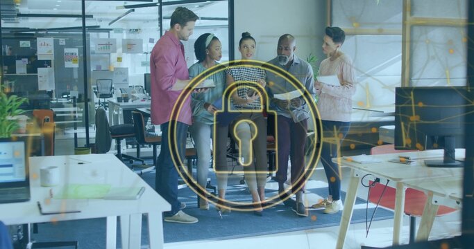 Meeting five colleagues in business-casual, discussing security at office with tablet and padlock