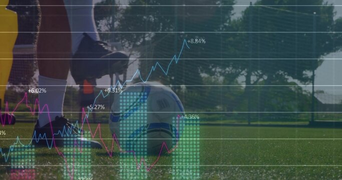 Standing soccer duo wearing yellow bibs placing white-blue soccer ball on pitch, with data overlay