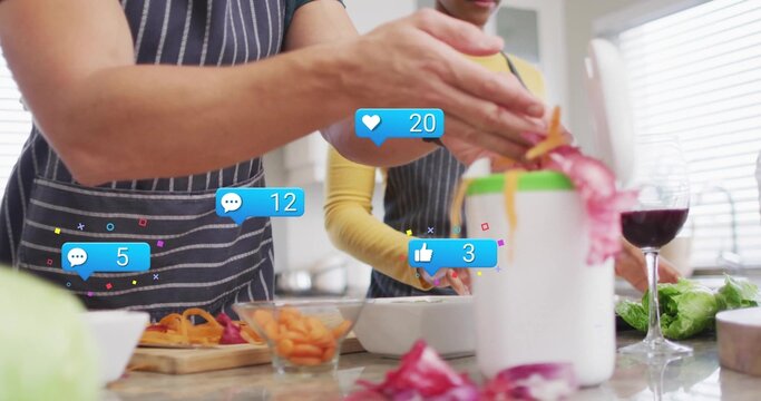 Peeling couple in aprons using peeler over peel bin at home kitchen with reaction icons - Powered by Adobe