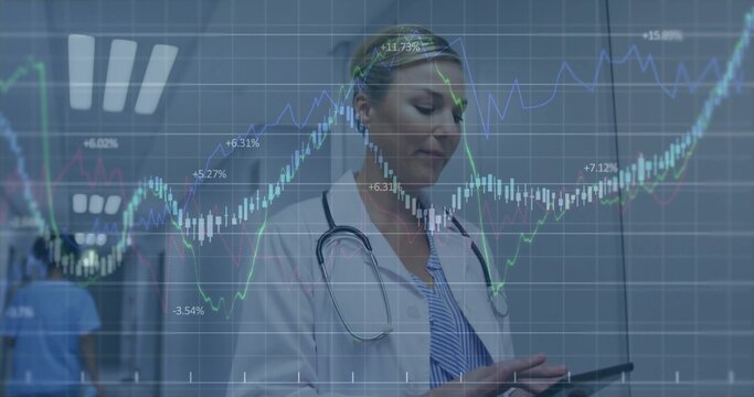 Reviewing doctor wearing white coat using tablet in clinic hall, analytics overlay, blue-scrubs