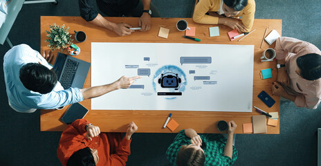 A diverse group of professionals engages in a collaborative meeting, discussing innovative ideas and planning strategies in a modern workspace with technology and creative tools. Trope