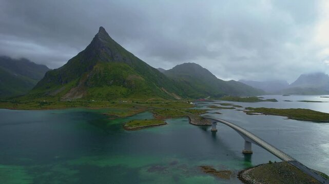 Drone aerial 4k footage of fredvang bridges stretches over tranquil waters, linking several fjiords. Nordland transportation infrastructure, lofoten islands, Norway	