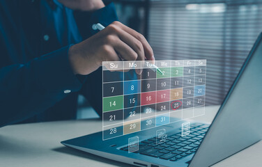 business person planning tasks with a digital calendar interface on a laptop, showing scheduling, organization, time management, and productivity workflow in a modern office environment.