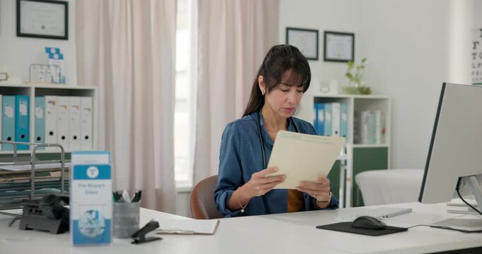 Hospital, doctor and woman with document, computer and medical research with patient records on web. Typing, info and mature person with diagnosis on paperwork, healthcare or think of treatment plans