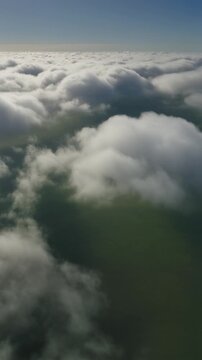 Orbit drone shot over low lumpy stratocumulus clouds