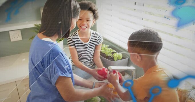 Mother handing pepper to boy, guiding rinsing at sink for food prep with blue overlays appearing