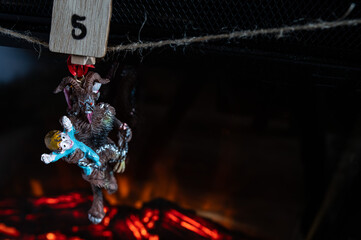 Krampus Ornament Carrying Child Hanging on Advent Garland Above Fireplace