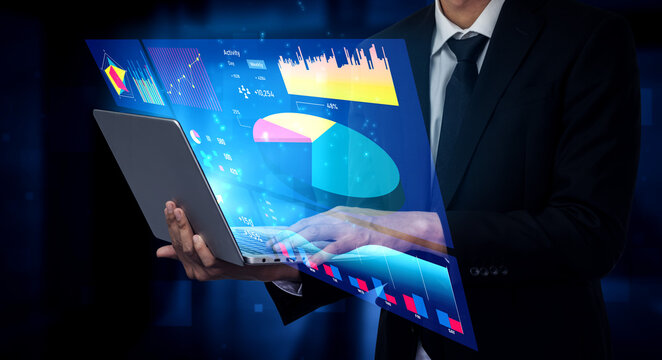 A businessman holds an advanced laptop displaying colorful data visualizations and graphs, symbolizing modern analytics and effective decision-making in business. Impute - Powered by Adobe