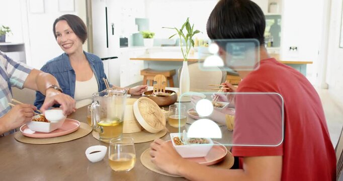 Family dining on noodles while camera shifting and revealing AR icons over red diner, tech demo