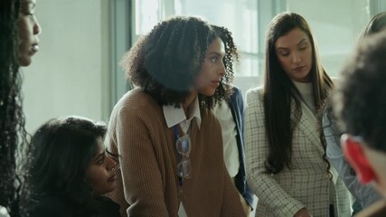 Professional women gather for a collaborative discussion in a well-lit office. They are engaged and focused, symbolizing teamwork and productive learning in a business environment.