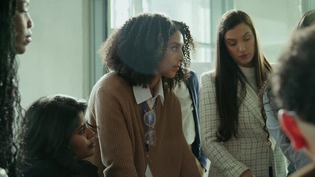 Professional women gather for a collaborative discussion in a well-lit office. They are engaged and focused, symbolizing teamwork and productive learning in a business environment.