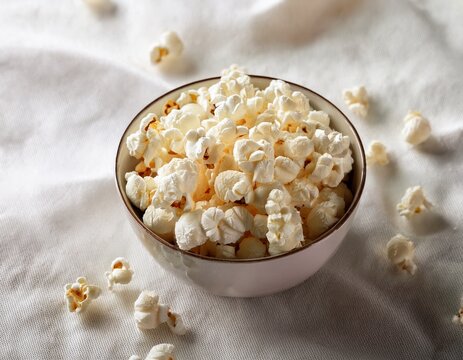 national popcorn day celebration with a bowl of freshly popped popcorn on a white cloth background