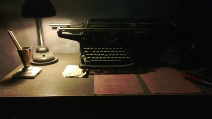 Vintage typewriter and lamp sit together on a desk, ready for use