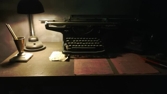 Vintage typewriter and lamp sit together on a desk, ready for use
