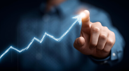 A business professional points to a digital graph symbolizing growth and success in a dark setting.