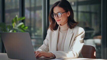 Smiling Businesswoman Working on Laptop in Modern Office - Powered by Adobe