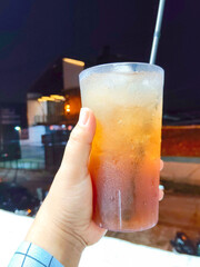 Refreshing Iced Sweet Tea Held Outdoors At Night