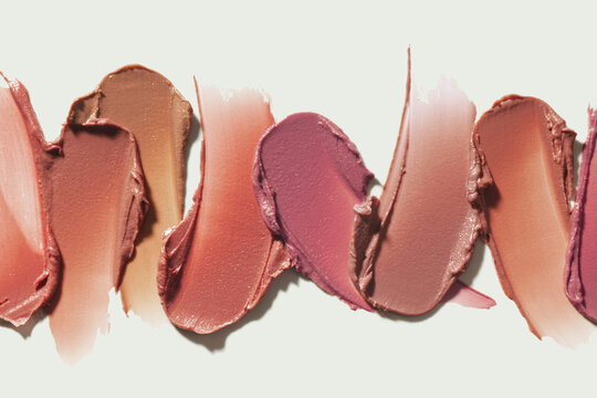 Lipstick nude pink red orange brown palette smudge background texture isolated on neutral beige background - Powered by Adobe