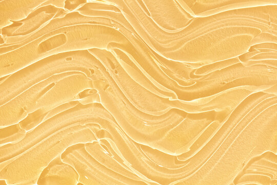 Cream gel yellow orange retinol, vitamin c, peptides or aha bha pha transparent cosmetic sample texture with bubbles backdrop