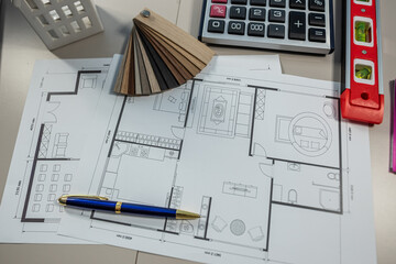 Interior design color palette with house floor plan and wood texture samples on desk