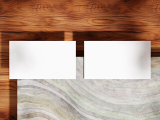 Business card mockup on a marble top with wooden floor and subtle light shadows.