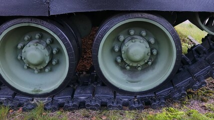 Close-up shot of a tank's wheels, suitable for military or war-themed illustrations