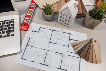 House blueprints with calculator and design tools, architecture and renovation workspace