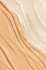 Cosmetic beige foundation and white primer on white isolated background