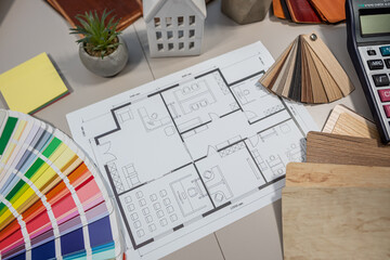 Laptop and house plans on architect table, interior design project, construction planning workspace