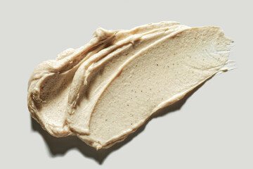 Skin care product row smears composition natural pink beige colored exfoliants enzyme peeling,  pits, grain ingredients on neutral beige background