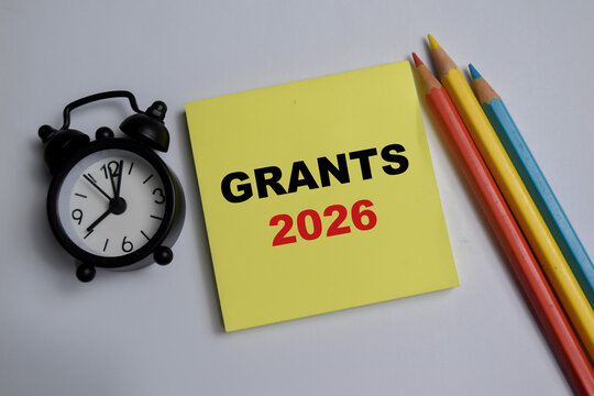 Concept of grants 2026 write on sticky notes isolated on Wooden Table.