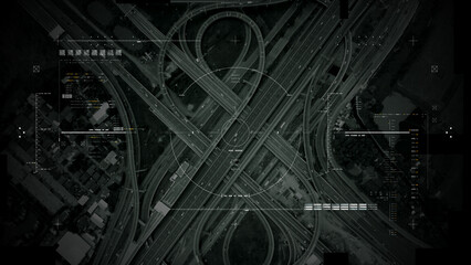 Aerial surveillance, military reconnaissance view of a complex highway interchange with HUD targeting graphics, creating a cinematic spy-drone atmosphere and intelligence-operation mood