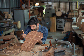 Luthier making guitar using traditional tools in workroom with manual tools