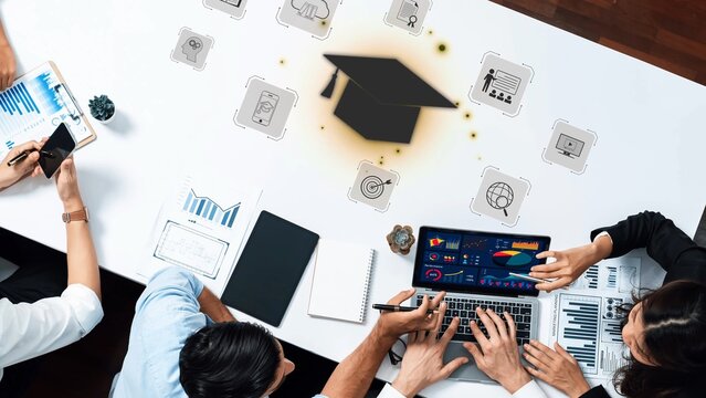 A team collaborating in a modern workspace, analyzing data on laptops and discussing education strategies with digital tools and visual aids for growth. Raster - Powered by Adobe