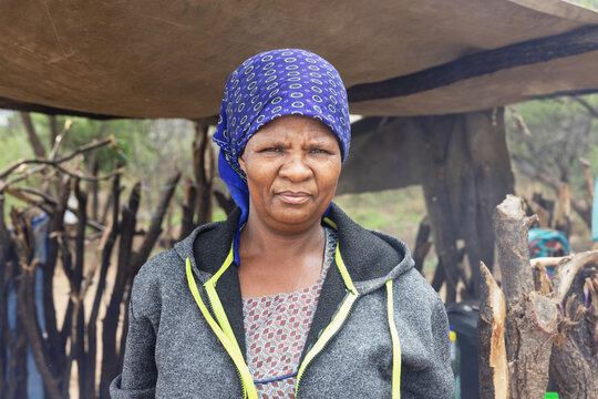 african village woman in front of shack. common in various rural African communities, Botswana, everyday life and cultural activities