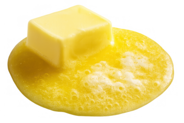 Butter block melting, forming a yellow puddle, an essential dairy ingredient for cooking and baking with transparent background