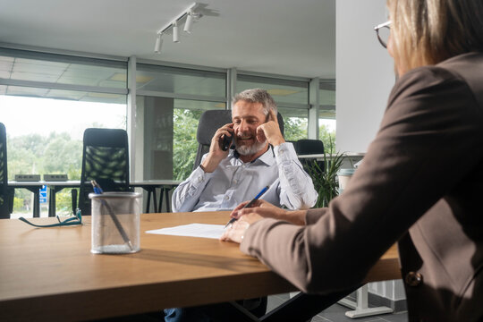 Financial consultant meeting with client in modern office space - Powered by Adobe